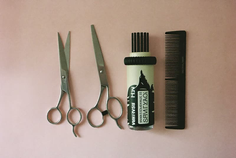 Grooming scissors, slicker brush and comb laid out
